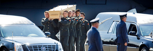Pallbearers carry a coffin towards a hearse during a ceremony to mark the return of the first bodies, of passengers and crew killed in the downing of Malaysia Airlines Flight 17. Photo / AP