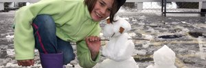 COLD COMFORT:Mauriceville School pupil Mackaylah Sutton, 9, shows off her snowman.