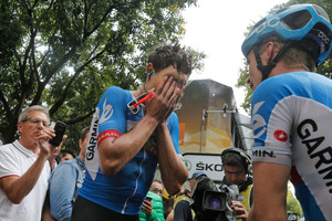 New Zealand's Jack Bauer, left, who rode in the two-man breakaway all of the race, is comforted by a teammate as he cries after being caught by the sprinting pack. Photo / AP