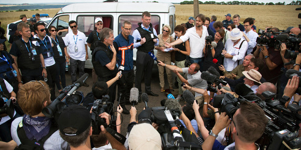 International forensic experts and members of the OSCE mission speak to the media near the crash site in Ukraine. Photo / AP
