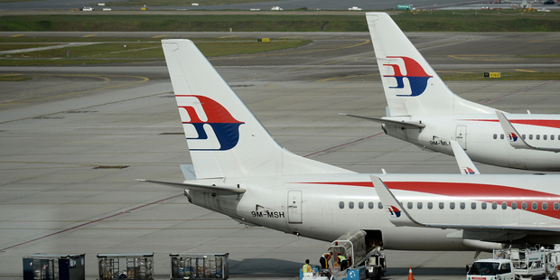 Malaysian Airlines ground crew loads cargo into a Malaysia Airline plane on the tarmac at Kuala Lumpur International Airport. Photo / AP