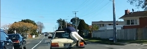 The YouTube clip shows a man clinging to a moving vehicle travelling through the streets of Tauranga. Police said the incident highlights an "obvious lack of regard for personal safety".
