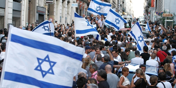 Supporters of Israel yesterday wave flags and shout slogans as they demonstrate in Marseille, France. Photo / AP