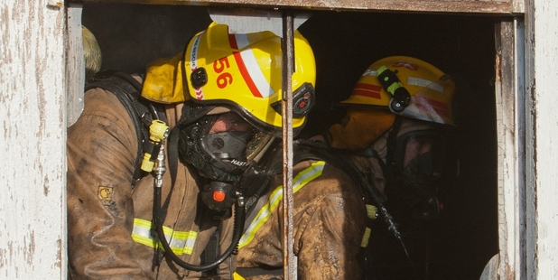Fire crews in a vacant Hastings house badly damaged by a suspicious blaze early yesterday. Police were investigating reports squatters had been sheltering on the property. Photo / Glenn Taylor