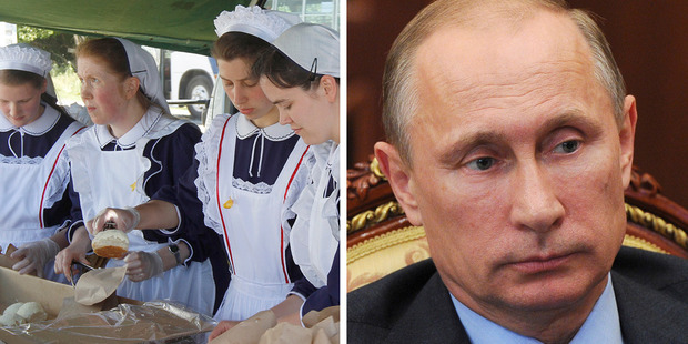 Members of Gloriavale and Russian President Vladimir Putin. Photo / NZH, AP