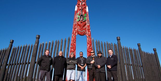 Fulton Hogan Construction Alliance project director Andrew Johnson, kaumatua Teia Williams, carvers Noel McAllister, Jason Puata, Joel Komene, Dean Flavell and Wayne Troughton in front of the waharoa.