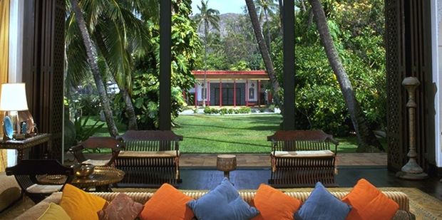 The Shangri La living room floor-to-ceiling window slides into the floor. Beyond, at the foot of the garden, is the playhouse. Photo / David Franzen