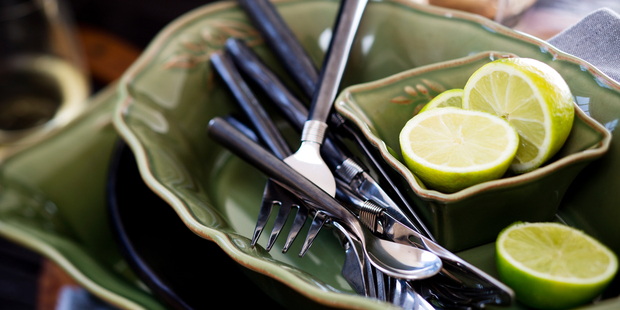 Green roasting dishes and bowls and cutlery from French Country Collections. Photo / Babiche Martens.