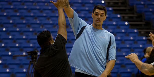 Basketballer Steven Adams shows All Black wing Julian Savea how it's done at the training clinic in Auckland yesterday. Picture / Brett Phibbs