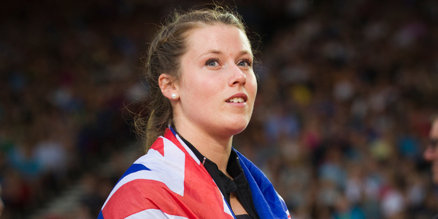 New Zealand Womens Hammer Thrower Julia Ratcliffe carries the NZ flag at Hampden Park in Glasgow. Photo / Greg Bowker