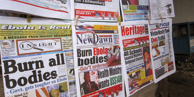 A close up of newspaper front pages focusing on the Ebola outbreak, including a newspaper, left, reading 'Burn all bodies' in the city of Monrovia, Liberia. Photo / AP