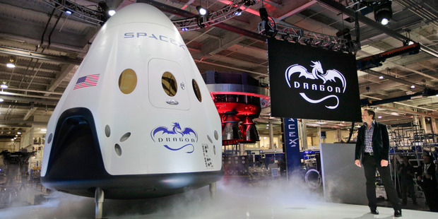 Elon Musk, right, unveils the SpaceX Dragon V2 spacecraft in May. SpaceX believes it should be considered as an option to supply the US Military. Photo / AP