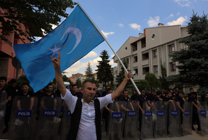 A man waves a Turkistan flag as Uighurs living in Turkey protest the deaths of people allegedly killed by Chinese security in China's far-western Xinjiang Uighur Autonomous Region. Photo / AP