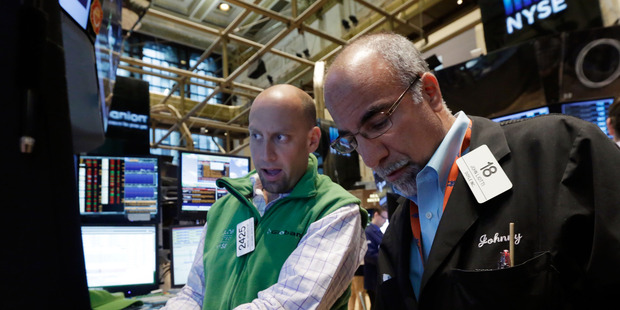 Specialist Meric Greenbaum, left, and trader John Liotti work on the floor of the New York Stock Exchange. File photo / AP