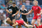 New Zealand's Bryce Heem, left, is stopped by Canada's Harry Jones during the Rugby Sevens Pool A match 1 between New Zealand and Canada. Photo / AP