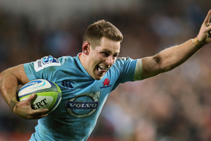 New South Wales Waratahs' Bernard Foley begins to celebrate just before scoring a try against the Brumbies during last night's game. Photo / AP