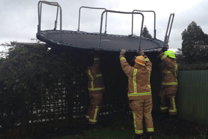 It wasn't all high drama and heroics for Northland firefighters in the recent storm. Aimee Ruka sent in this shot of Kaikohe firefighters rescuing her young son's trampoline after an unscheduled flight across her backyard and onto a neighbour's fence. The volunteers were on their way back to the station after clearing a road of one of many downed trees when they stopped by to retrieve the wayward trampoline. PHOTO / AIMEE RUKA