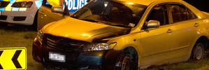 Police inspect the car they were chasing which the offender was driving on its steel rims. Photo / Alan Gibson