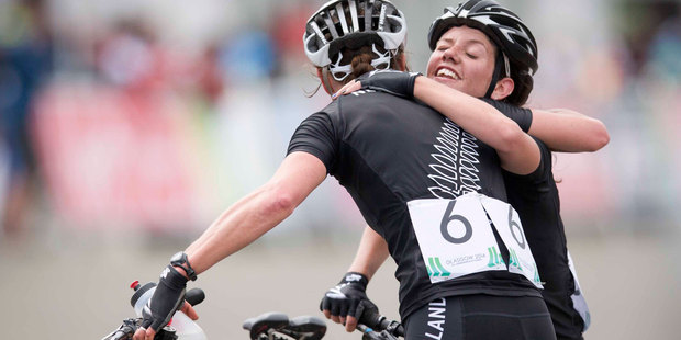 Karen Hanlen and Kute Fluker, left, embrace at the finish line of the mountain biking. Photo / Greg Bowker