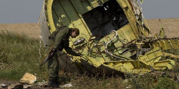 A pro-Russian rebel touches the MH17 wreckage. Photo / AP
