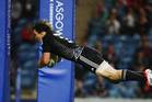 New Zealand's Sam Dickson dives over to score a try during the rugby sevens match between New Zealand and Barbados in Glasgow this morning. Photo / Getty Images
