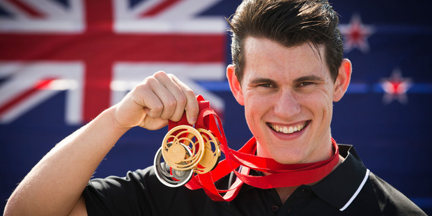 New Zealand track cyclist Sam Webster poses with his three medals. Photo / Greg Bowker