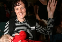 LATCHED: Hayley Inder, of Masterton, with 9-month-old Mali, raises her hand to be counted.