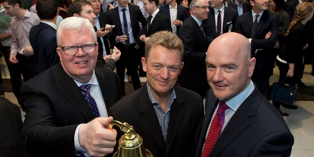NZX chief executive Tim Bennett (left), Gentrack chief executive James Docking (centre) and chairman John Clifford ring the bell as the company lists on the NZX. Photo / Brett Phibbs