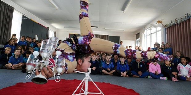 Contortionist Jade Xiao from China wowing the kids at Onerahi Primary School by balancing herself using the strength of her teeth. Photo / John Stone