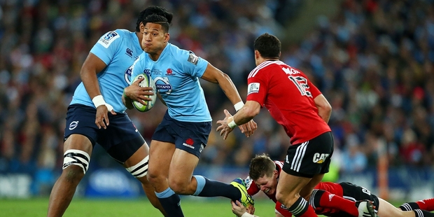 Israel Folau runs the ball up for the Waratahs last night. Photo / Getty Images
