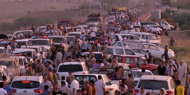 Iraqi people from the Yazidi community arriving in Irbil in northern Iraq after Islamic militants attacked the towns of Sinjar and Zunmar. Photo / AP
