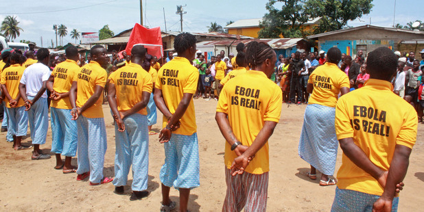 People working for a petroleum company take part in an Ebola awareness campaign to try and prevent the deadly Ebola virus spreading in the city of Monrovia, Liberia. Photo / AP