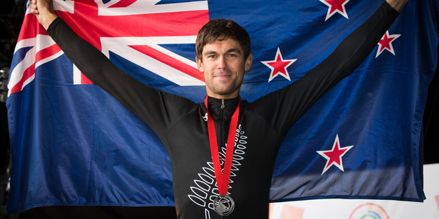 Jack Bauer celebrates after claiming the silver medal in the men's road race. Photo / Greg Bowker