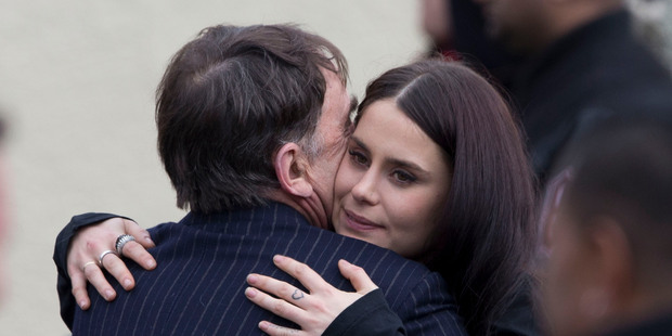 Millie Elder-Holmes (left) is comforted later at the Waikumete Crematorium. Photo / Brett Phibbs, Sarah Ivey