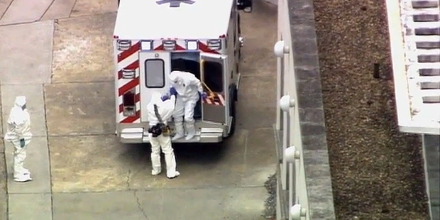 An ambulance arrives with Ebola victim Dr. Kent Brantly, right, to Emory University Hospital. Photo / AP