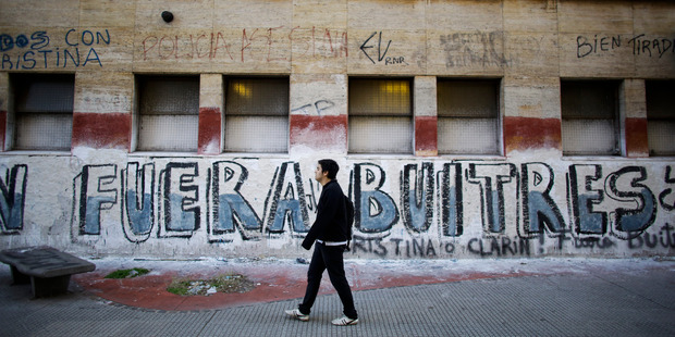 Graffiti that reads in Spanish, "Out Vultures" in reference to the dispute between the Argentine government and a US hedge fund, known locally as "vulture funds,". Photo / AP