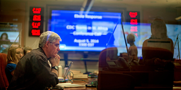 U.S. Centers for Disease Control and Prevention officials sit in on a conference call about Ebola with CDC team members deployed in West Africa. Photo / AP
