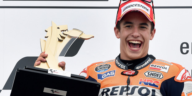 Marc Marquez lifts his winners trophy after the MotoGP race at the Sachsenring circuit in Hohenstein-Ernstthal, Germany. Photo / AP