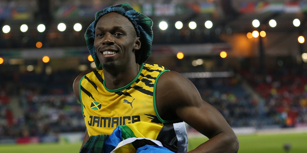 Usain Bolt of Jamaica wears a tartan hat after competing in the men's 4x100 meter relay race during the Commonwealth Games. Picture / AP