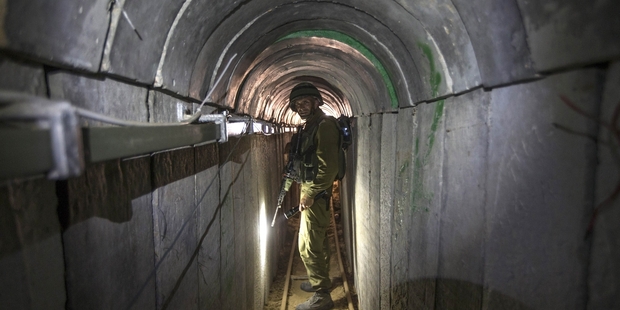An Israeli army officer inspects a tunnel allegedly used by Palestinian militants. Picture / AP