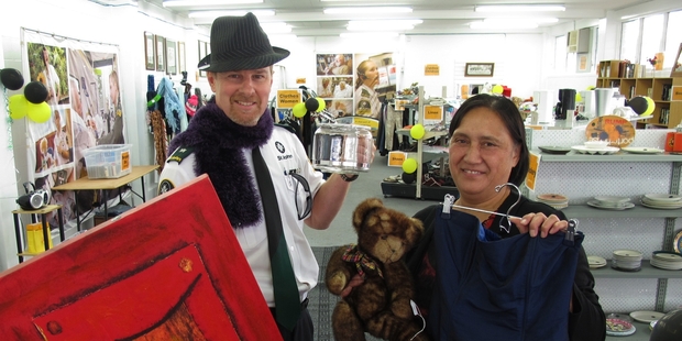 Showing off some of the wares at Kaikohe's newest op shop are St John Mid North manager Mark Going and Kaikohe ambulance station manager Susan Dunn. Photo / Peter de Graaf