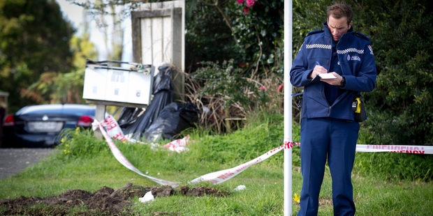 Police guard the scene in Don Buck Rd, Massey, where Connor Morris was killed with what was believed to be a machete. Picture / Sarah Ivey