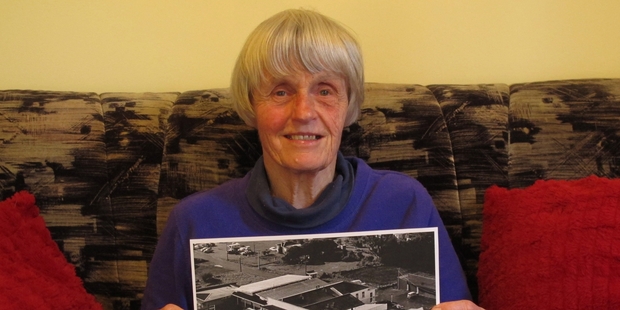 Karen Fletcher with a photo of the Kaikohe Hotel in better times. The aerial picture was taken by the RNZAF in 1968. Photo / Peter de Graaf