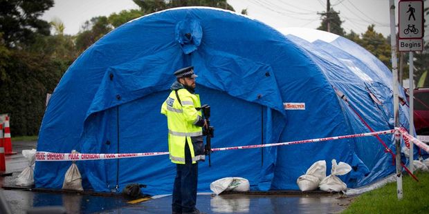 Specialist Police searchers working near to where Police are guarding the scene of a incident in Don Buck Road, Massey. Photo / New Zealand Herald / Sarah Ivey