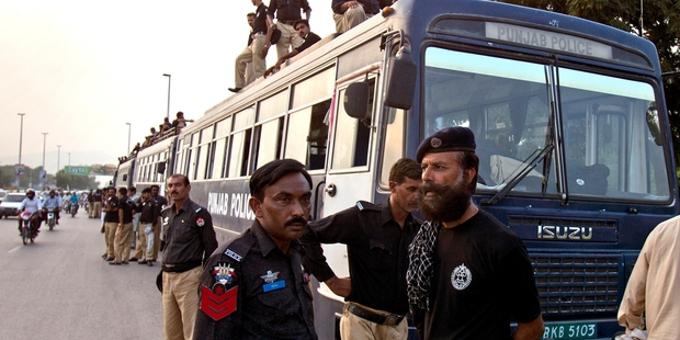 Police deploy in Islamabad where roads to Parliament are being blocked off. Photo / AP
