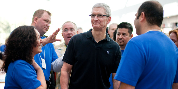 Apple store employees greet CEO Tim Cook at a new Apple Store in California. Photo / Getty