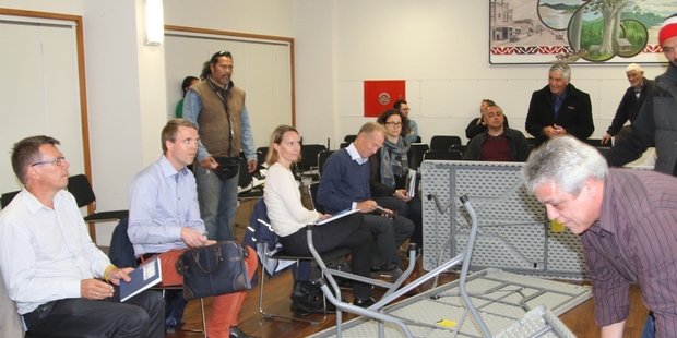 Te Rarawa Runanga chairman Haami Piripi rearranges the tables that had been upturned by protesters during a meeting it had organised with Norwegian oil giant Statoil in Kaitaia.Photo / Petrina Hodgson