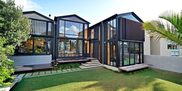 The three-bedroom Takapuna house lets in lots of natural light. The interior features cedar and plywood.