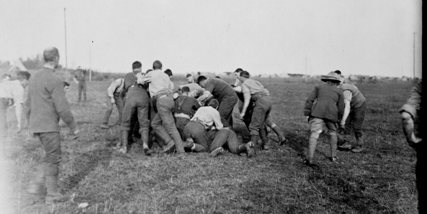 Henry Armytage snapped these NZ soldiers playing rugby on October 12, 1918, in Fontaine, France. Photo / Alexander Turnbull Library