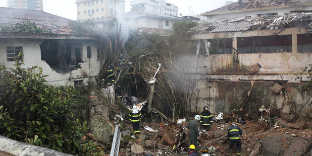 Firefighters work at the crash site in Santos, Brazil. Photo / AP
